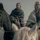 Alexander Skarsgård and Anya Taylor-Joy on horses on a beach.